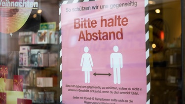 Ein Schild mit dem Hinweis auf die Abstandsregelung an einem Geschäft. | Bild: BR/Johanna Schlüter