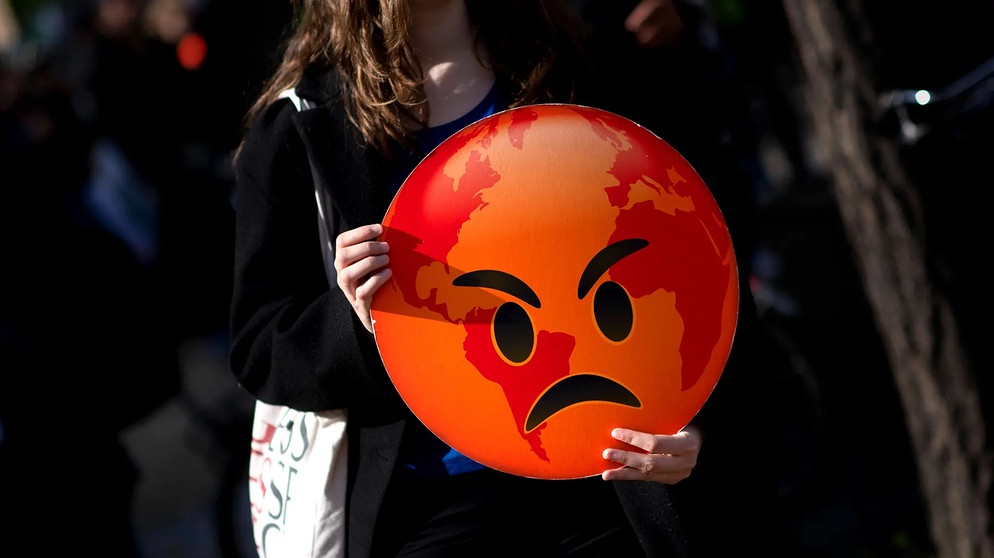 Demonstrant mit Plakat, Symbol Erde wütend | Bild: IMAGO/Stefan Boness/Ipon