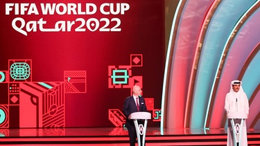Fußball: WM, Auslosung der Vorrunde in Doha. Fifa-Präsident Gianni Infantino (l) und Scheich Tamim bin Hamad Al Thani, Emir von Katar, stehen zu Beginn der Auslosung auf der Bühne. | Bild: picture alliance/dpa | Christian Charisius