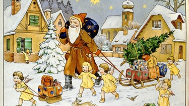 Sankt Nikolaus zieht an einem mit Geschenken und Christbaum beladenen Schlitten, dabei helfen ihm kleine Engel. Um 1920. | Bild: picture alliance / imageBROKER | Dr. Wilfried Bahnmüller