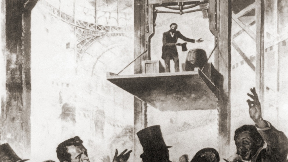 Elisha Graves Otis präsentiert auf der Weltausstellung 1854 in New York seine Erfindung: eine automatische Notfallbremse für Aufzüge. | Bild: picture-alliance/dpa/Everett Collection
