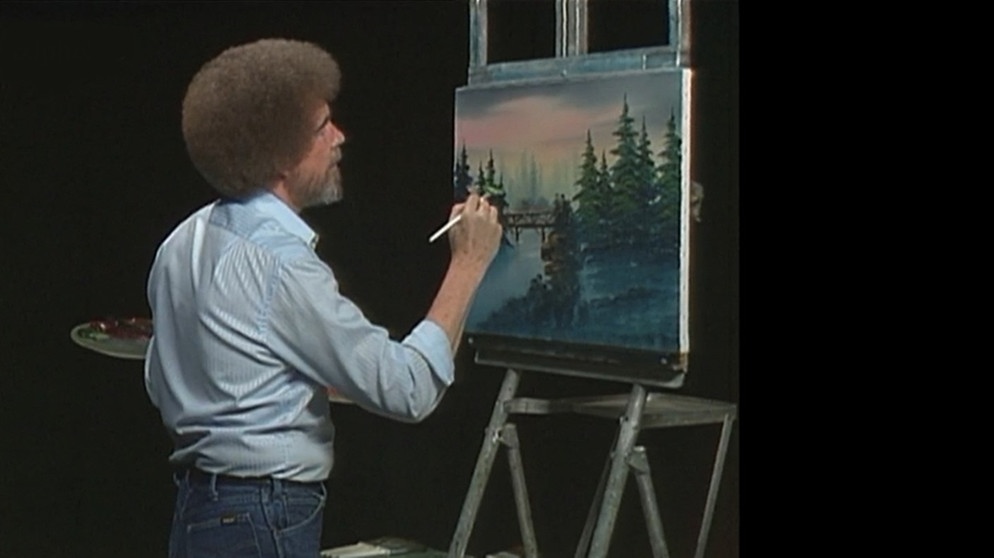 Bob Ross malt ein Ölbild im TV-Studio bei der Produktion von "The Joy of Painting".  | Bild: BR / Bob Ross Company
