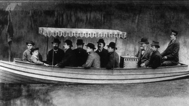 Daimler Motorboot auf dem Neckar bei Bad Cannstadt (1886). Der schwäbische Konstrukteur Gottlieb Daimler baute das erste Motorrad und das erste Motorboot der Welt. Dann montierte er einen Benzinmotor in eine Kutsche. Das erste Auto mit vier Rädern war fertig! | Bild: picture-alliance/dpa