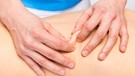 Hände, die Haut bei der Massage zusammendrücken. | Bild: colourbox.com