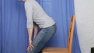 Gegen Rückenschmerzen hilft richtiges Sitzen - wie hier im Bild demonstriert | Bild: BR / Markus Konvalin