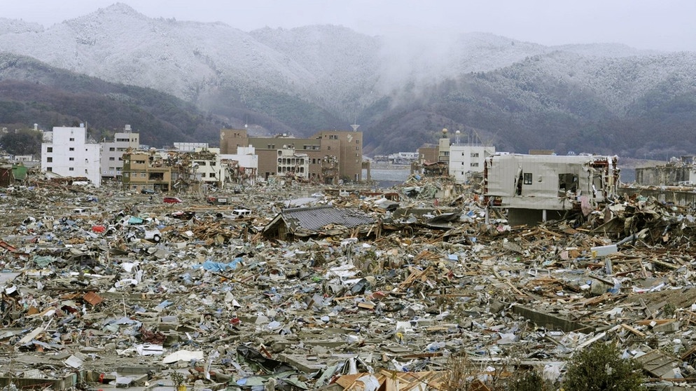 Onagawa in der Präfektur Miyagi im Nordosten Japans ist nach dem schweren Erdbeben und Tsunami vom 11. März 2011 ein einziges Trümmerfeld. Starke seismische Aktivitäten und Verschiebungen tektonischer Platten können riesige Flutwellen, japanisch: Tsunamis auslösen. | Bild: picture alliance / dpa | Kyodo