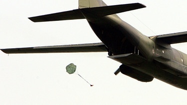 Ein Paket wird an einem Fallschirm aus einem Flugzeug abgeworfen: So ähnlich sollte die Automatische Kidnapper-Falltür-Zusammenschnür-Abwurf-Maschine funktionieren, die mit einem Ig-Nobelpreis 2013 gewürdigt wurde | Bild: picture-alliance/dpa