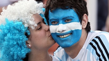 Argentinische Fans küssen sich auf die Wange. Die berühmtesten Filmküsse, Kuss-Traditionen in anderen Ländern und Reaktionen des Körpers während des Knutschens - hier erfahrt ihr alles Wichtige rund um den Kuss. | Bild: picture-alliance/dpa