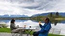 Durchwachsenes Wetter im Mai 2021 in Bayern. In diesem Biergarten in Uffing am Staffelsee sitzen nur wenige Gäste, und die sind warm eingepackt. Doch auch wenn es uns anders vorkam: Der Frühling 2021 war nur ein halbes Grad kühler als der langjährige Durchschnitt. | Bild: dpa-Bildfunk/Angelika Warmuth
