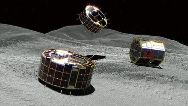 Asteroiden-Landegeräte MINERVA-II auf Ryugu (Grafik). Am 21. September 2018 landeten die beiden Minerva-Lander der japanischen Raumfahrtbehörde JAXA erfolgreich auf dem Asteroiden Ryugu, den die Sonde Hayabusa 2 umkreist. Auch das deutsche Landegerät MASCOT wird auf diesem Asteroiden abgesetzt. | Bild: Jaxa