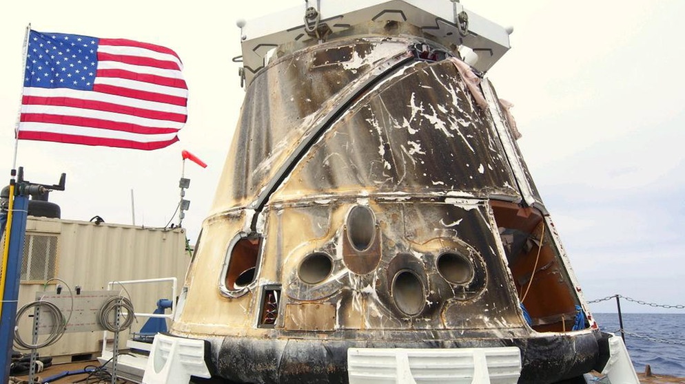 So sieht Dragon nach der Landung und Bergung aus dem Meer aus. Elon Musks private Raumfahrtfirma SpaceX hat die Dragon-Raumkapsel entwickelt. Sie übernimmt als Ersatz für die Space Shuttles der NASA die Transportflüge zur Internationalen Raumstation. | Bild: picture-alliance/dpa