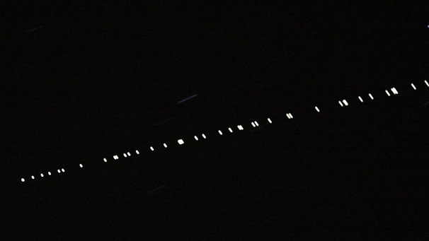Diese Aufnahme ist im Mai 2021 in Kansa, USA, entstanden. Mit der Langzeitbelichtung sind die Satelliten der Starlink-Konstellation des US-amerikanischen Unternehmens SpaceX als Kette am Nachthimmel zu erkennen.  | Bild: picture alliance / ASSOCIATED PRESS | Reed Hoffmann